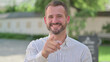 © stockbakers - Outdoor Portrait of Mature Adult Man Pointing at Camera, Approve