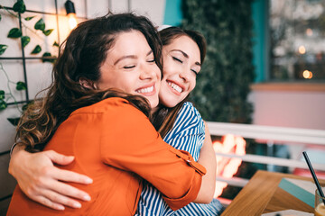 Two young friends enjoying together in restaurant.