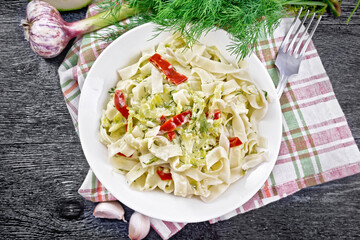 Wall Mural - Fettuccine with zucchini and hot peppers in plate on board top