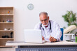© Elnur - Old male doctor working in the clinic