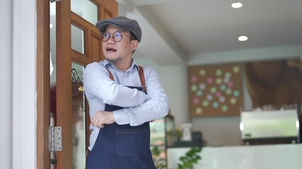 Wall Mural - 4K Portrait of Smiling Asian man coffee shop manager open shop door and standing with crossing arms. Male cafe owner waiting for customer with happiness. Small business restaurant entrepreneur concept