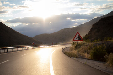 Highway perspective view reflecting the light of the setting sun. long roads and new adventures.