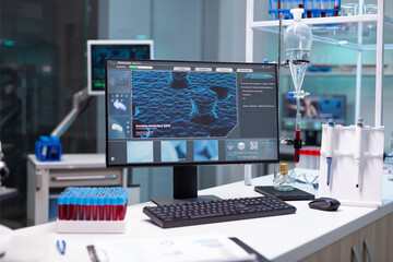 Wall Mural - Computer with microbiology virus expertise on display standing on table during medicine biochemistry genetic experiment in pharmaceutical hospital laboratory. Healthcare treatment development