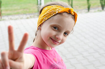 Happy European girl smiling. In the summer he plays outside.