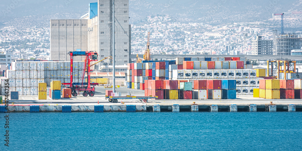 Warehouse and shipping container carriers at the port of Limassol, Cyprus  - obrazy, fototapety, plakaty 