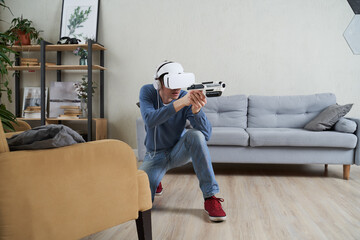 Wall Mural - man with virtual reality headset and blaster is playing game.