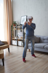 Wall Mural - man with virtual reality headset is playing game.