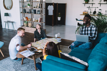 Wall Mural - Smiling multiethnic people gathering in modern apartment