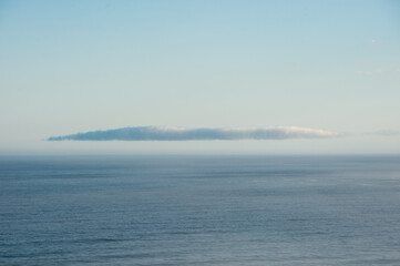 Wall Mural - A lone cloud floats over the ocean