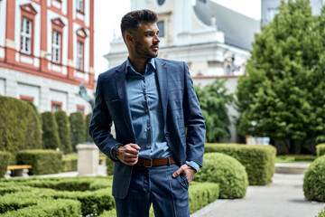 Wall Mural - Handsome stylish man in a classic navy blue suit