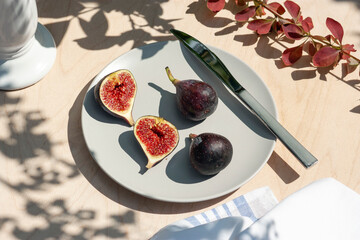 Ripe figs on grey plate in natural light