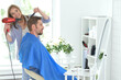 © aletia2011 - Man having a haircut from female hairdresser at salon