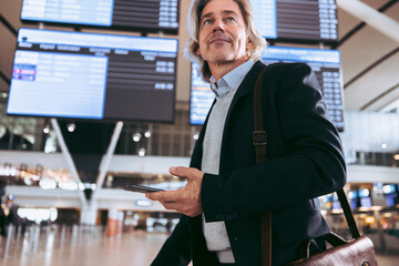 Wall Mural - Businessman on transit at airport during international journey