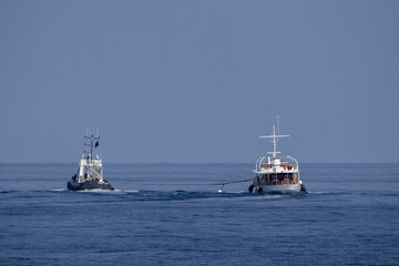 tugboat towing small boat ship