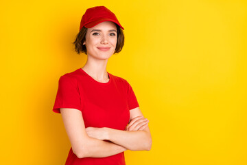 Wall Mural - Photo of nice optimistic brown hair lady crossed arms wear t-shirt cap isolated on yellow background