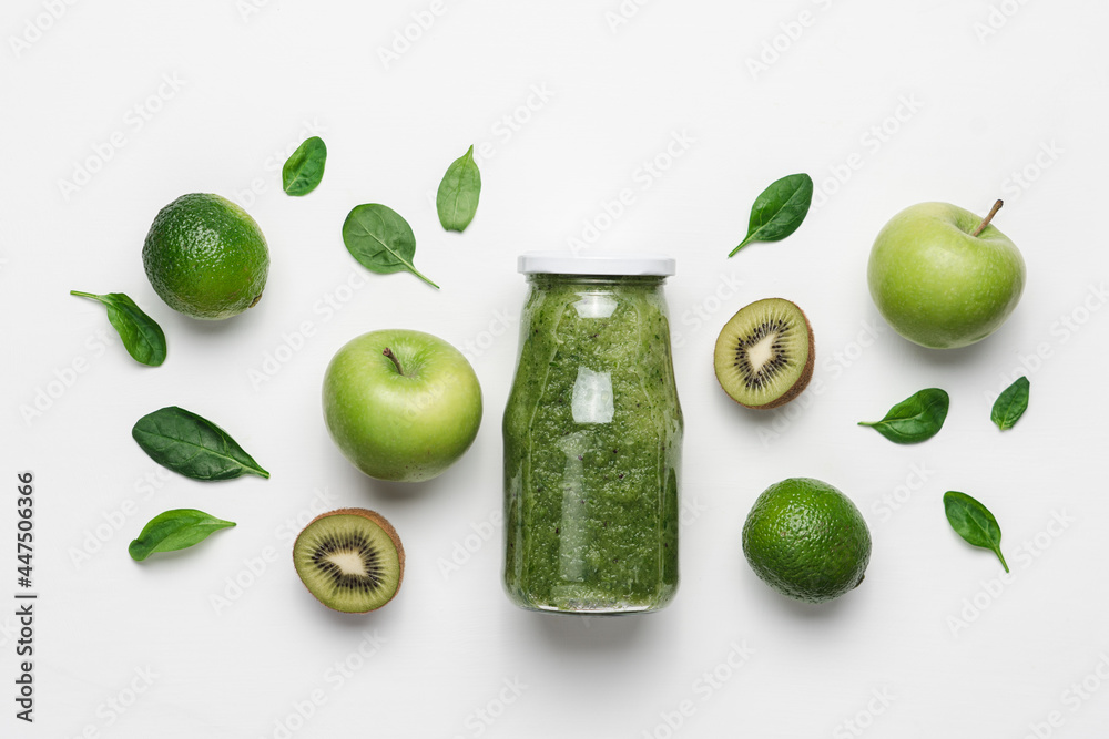Green smoothie in glass bottle and organic vegetables and fruits. White background, top view - obrazy, fototapety, plakaty 