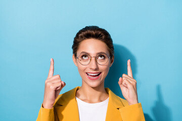 Poster - Portrait of attractive cheerful woman demonstrating up copy space recommend isolated over bright blue color background