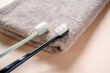 Ultra-fine toothbrushes with soft bristles on a bath towel top view, dental care and hygiene trends