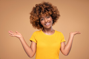 Wall Mural - Beauty portrait of young attractive afro woman with perfect smile and delicate glamour makeup with yellow eyeliner.