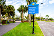 Venice, Florida retirement city at Gulf of Mexico with palm trees on street road with information direction sign to beach, Higel park and south jetty boat ramp