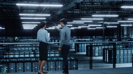 Poster - Data Center Female System Administrator and Male IT Specialist Talk, Use Laptop Computer. Information Technology Engineers work on Cyber Security Network Protection in Cloud Computing Server Farm.