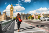 Fototapeta Londyn - London city urban lifestyle tourist woman walking. Businesswoman commuting going to work on Westminster bridge street early morning. Europe travel destination, England, Great Britain, UK.