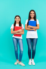 Wall Mural - happy pupil and student. mom and teen girl study. private teacher and child holding copybook