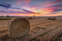 Beautiful Summer Sunrise Over Fields With Hay Bales