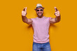 © zamuruev - Young handsome man wearing casual t-shirt standing over isolated yellow background pointing with finger to the camera and to you, hand sign, positive and confident gesture