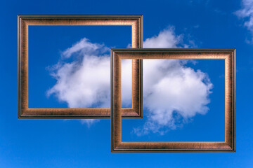 two simple frames made of wood for a picture on a background on a blue sky with a white cloud