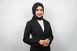 Beautiful young asian muslim business woman confident and smiling, isolated on gray background
