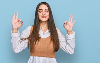 Wall Mural - Young beautiful woman wearing casual white shirt relax and smiling with eyes closed doing meditation gesture with fingers. yoga concept.