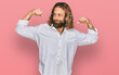 © Krakenimages.com - Handsome man with beard and long hair wearing casual clothes showing arms muscles smiling proud. fitness concept.