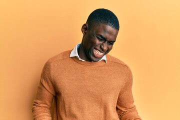 Young african american man wearing casual clothes very happy and excited doing winner gesture with arms raised, smiling and screaming for success. celebration concept.