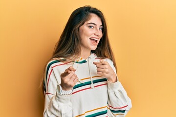 Sticker - Young caucasian woman wearing casual clothes pointing fingers to camera with happy and funny face. good energy and vibes.