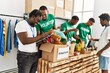 © Krakenimages.com - Group of young african american volunteers working at charity center.