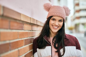 Wall Mural - Young hispanic girl smiling happy standing at the city.