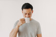 © Sevendeman - Asian man is drinking coffee or tea isolated on white background.