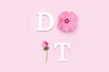 Wall Mural - Do it. Motivational quote from white letters and beauty natural flowers on pink background. Creative concept inspirational quote of the day
