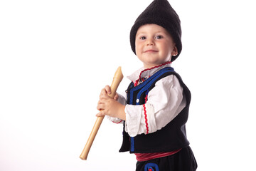 Baby boy in traditional Bulgarian folklore costume posing with musical flute, Bulgaria