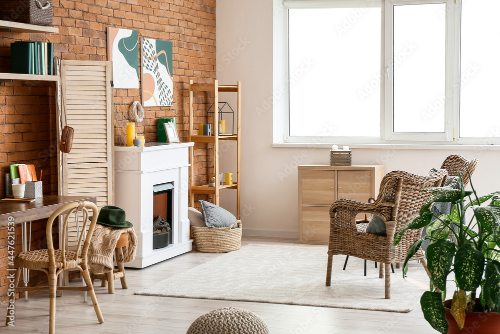 Interior of stylish room with fireplace and folding screen