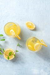 Wall Mural - Lemonade. Homemade fresh ice tea with lemon and mint, shot from the top on a grey slate background with copy space