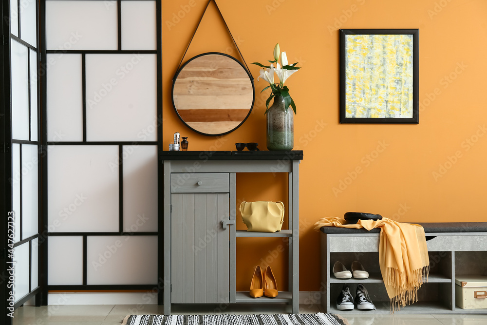 Interior of stylish hallway with folding screen