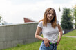 Portrait of a young woman in white t-shirt. Outdoor photo.