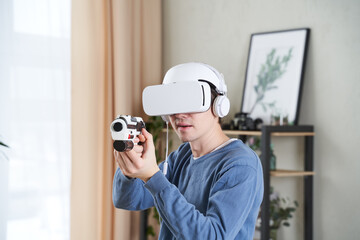 Wall Mural - man with virtual reality headset and blaster is playing game.