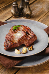 Wall Mural - Closeup view of beef steak with a piece of butter