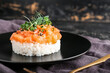 Delicious salmon tartar on dark background, closeup
