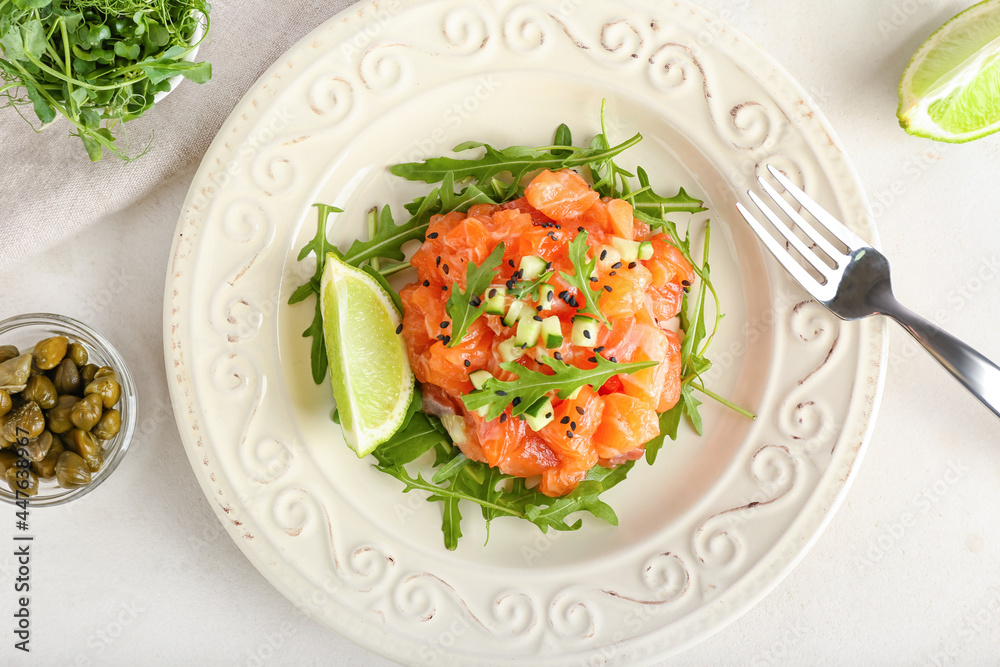 Delicious salmon tartar on light background