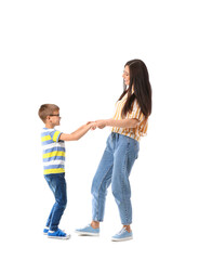 Poster - Dancing young woman and her little son on white background