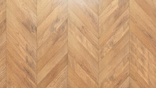 Light Wood Texture. Wooden Boards Arranged In A Chevron Parquet Pattern.
